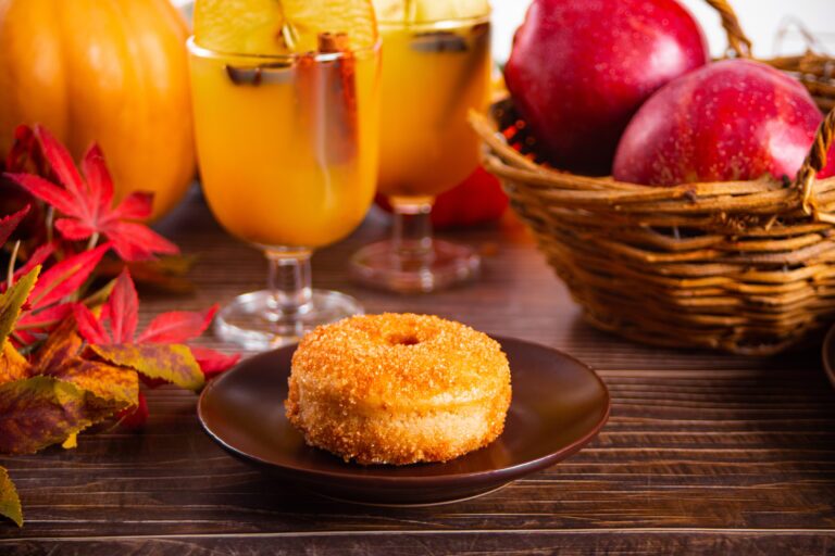 Sweet homemade apple cider donuts with cinnamon sugar on the wooden table Autumn food
