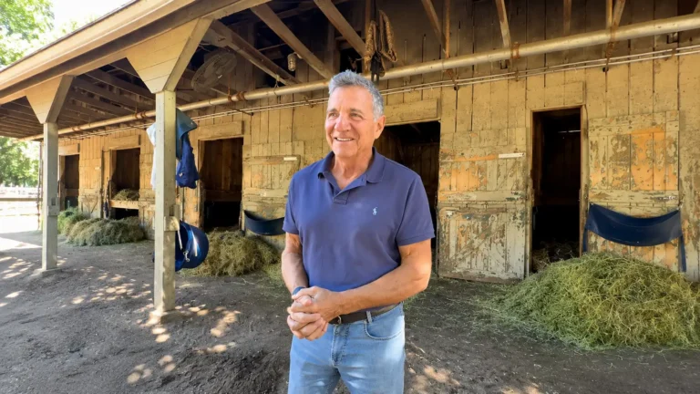 Michael Dubb outside horse stables in Saratoga Springs, NY at the 2026 Belmont Stakes Festival.